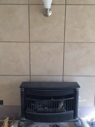 Ventless gas fireplace installed with a tiled surround
